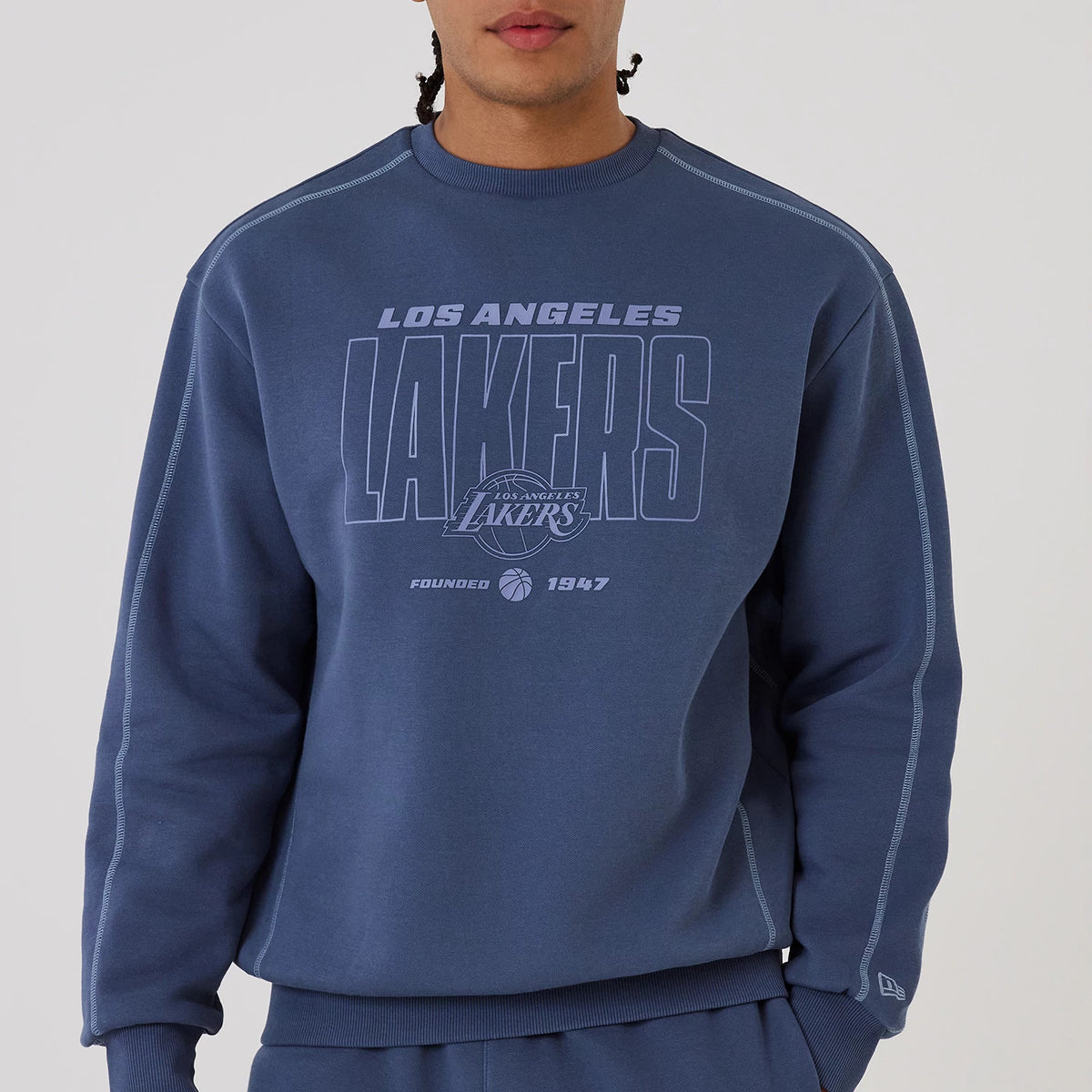 The model is wearing this NBA Graphic LA Lakers Crew Neck Sweater in dark blue. 4