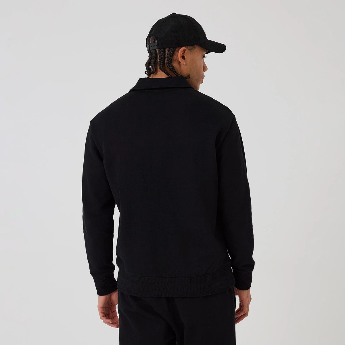 New Era New York Yankees MLB Black 1/4 Zip Sweater, back view on a model wearing a black cap, showing the plain black design with a high collar and ribbed cuffs and hem for a clean, modern look.