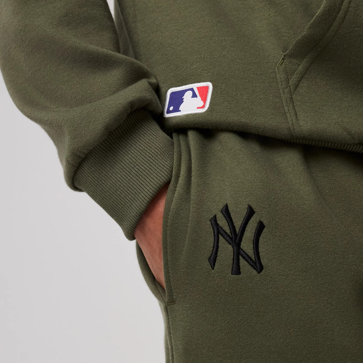 The model is wearing this MLB League Essential New York Yankees Joggers in green. 3