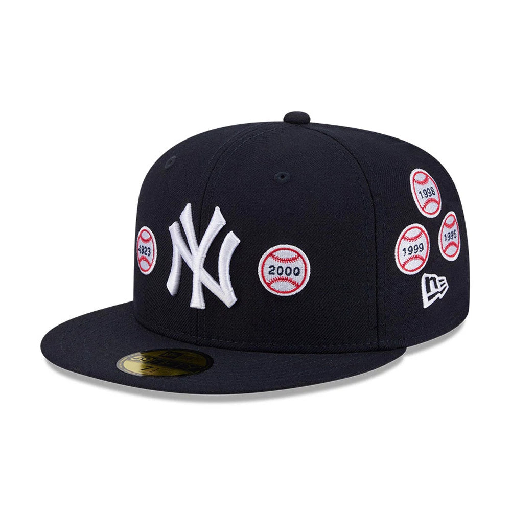 New York Yankees MLB X Spike Lee Patches Navy New Era 59FIFTY Fitted Cap, three-quarter view showing white raised New York Yankees logo on front panel, multiple red-bordered baseball year patches on the crown.