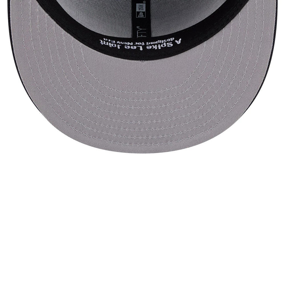 New York Yankees MLB X Spike Lee Flags Navy New Era 59FIFTY Fitted Cap, inside view showing a grey undervisor, black seam taping with white printed text, and a black sweatband showcasing Spike Lee Joint branding.