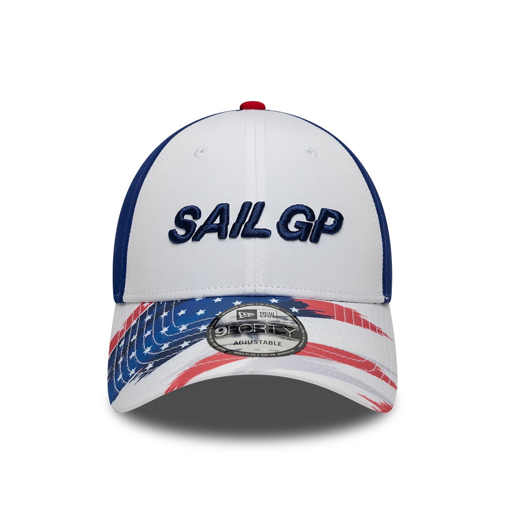 Sail GP USA Air Event White New Era 9FORTY Adjustable Cap, front view showing raised navy embroidered SAIL GP logo on the white crown, with a patterned visor featuring the American flag motif and a 9FORTY size sticker on the visor.