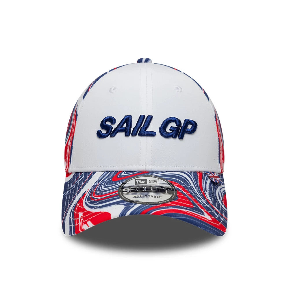 Sail GP UK Air Event White New Era 9FORTY Adjustable Cap, front view showing the raised navy embroidered SAIL GP logo on the white front panel, with a colourful red, white, and blue marbled pattern on the curved visor and a 9FORTY size sticker.