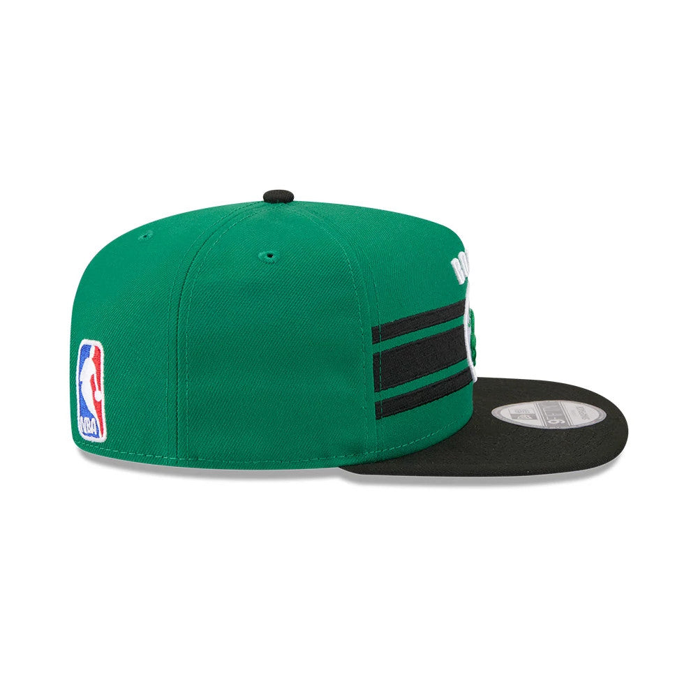 Boston Celtics NBA Tip Off 2026 Green New Era 9FIFTY A-Frame Snapback Adjustable Cap, side view showing the NBA logo at the bottom of the green back panel, contrasting black visor, and white raised embroidery on the front.