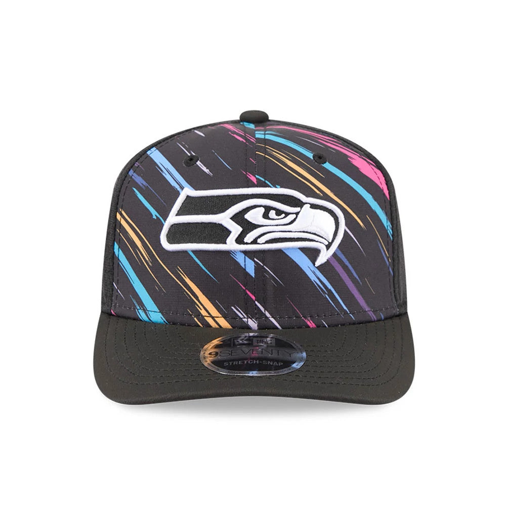 Seahawks NFL City Connect 2026 Black New Era 9SEVENTY Stretch Snap Adjustable Cap, front view showing the large white and black embroidered Seahawks logo on a multicoloured abstract brush stroke pattern crown, with a black curved visor.
