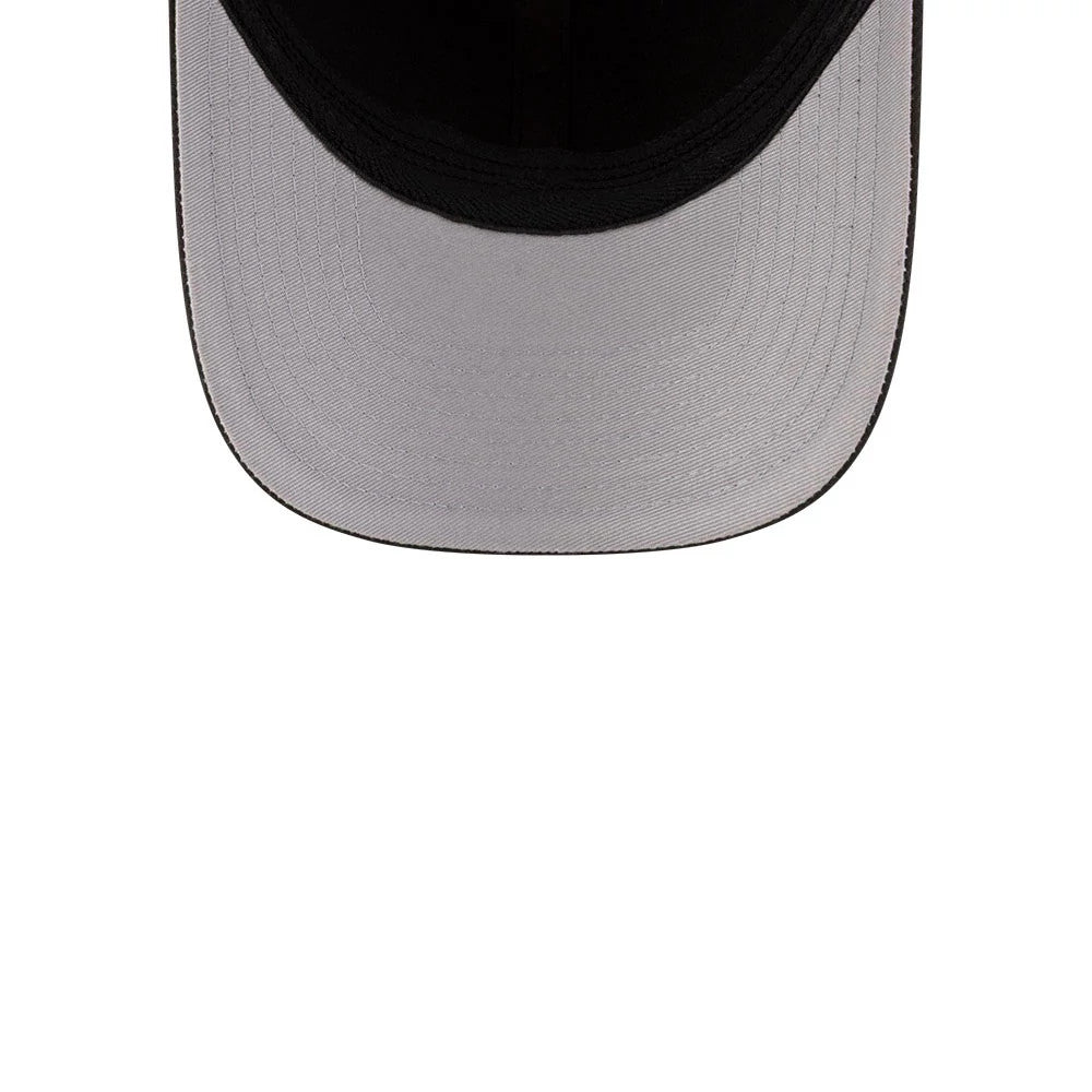 New York Knicks NBA Team Black New Era 39THIRTY M-Crown Stretch Fit Cap, inside view showing the white curved undervisor against the black interior lining, with detailed stitching along the curved edge and around the sweatband area.