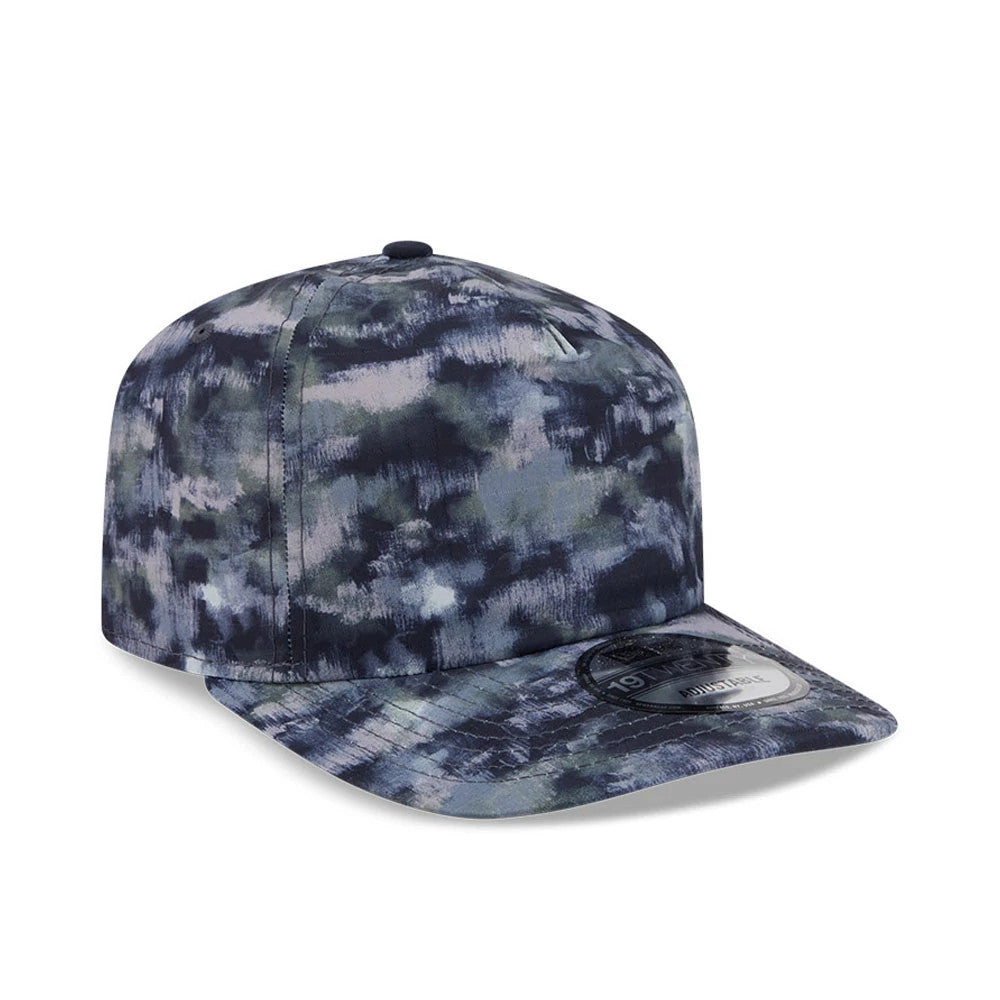 New Era Elevated Basics All Over Print New Era 19TWENTY Adjustable Cap, three-quarter view with a multi-blue and grey camo pattern, flat visor featuring a 19TWENTY size sticker, and a structured crown with matching top button and embroidered eyelets.