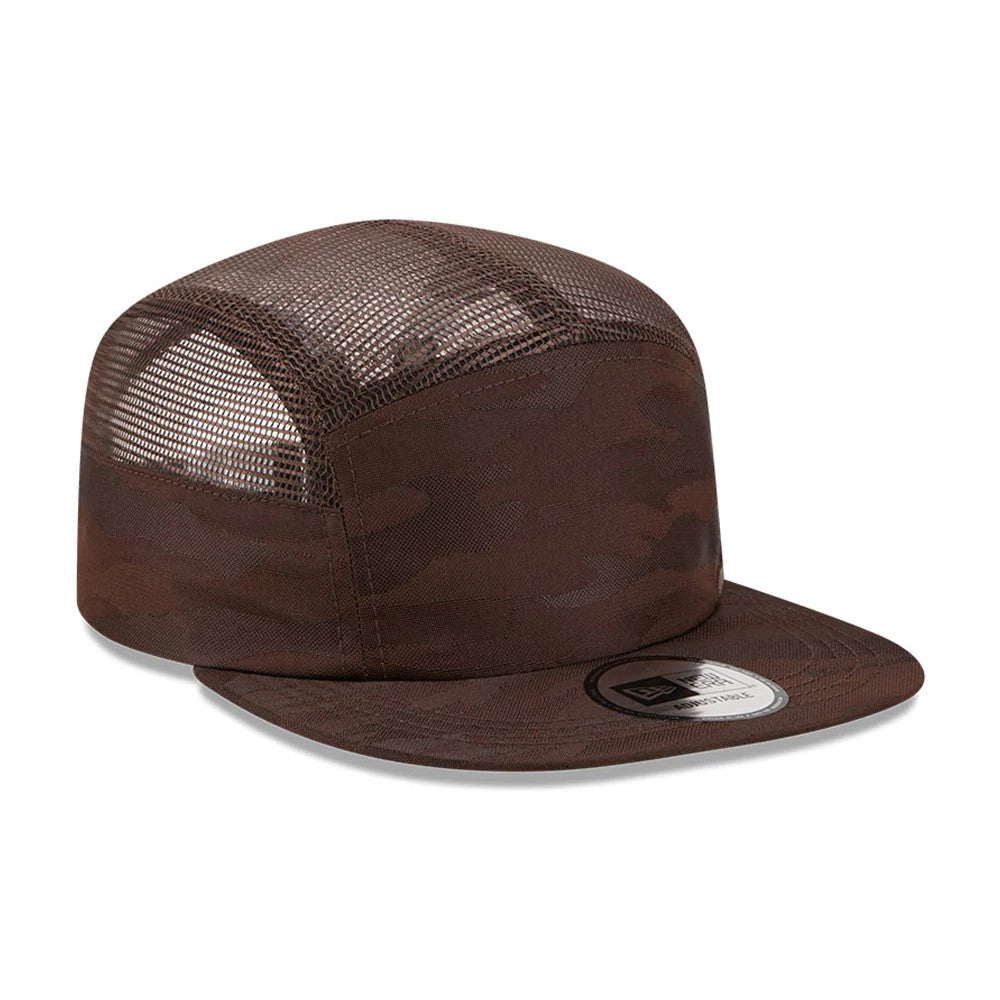 New Era Elevated Basics Woodland Camo Camper Cap, side view showing a brown camo-patterned front panel, a mesh side panel allowing visibility of the internal structure, and a flat camo visor with an attached New Era size sticker.