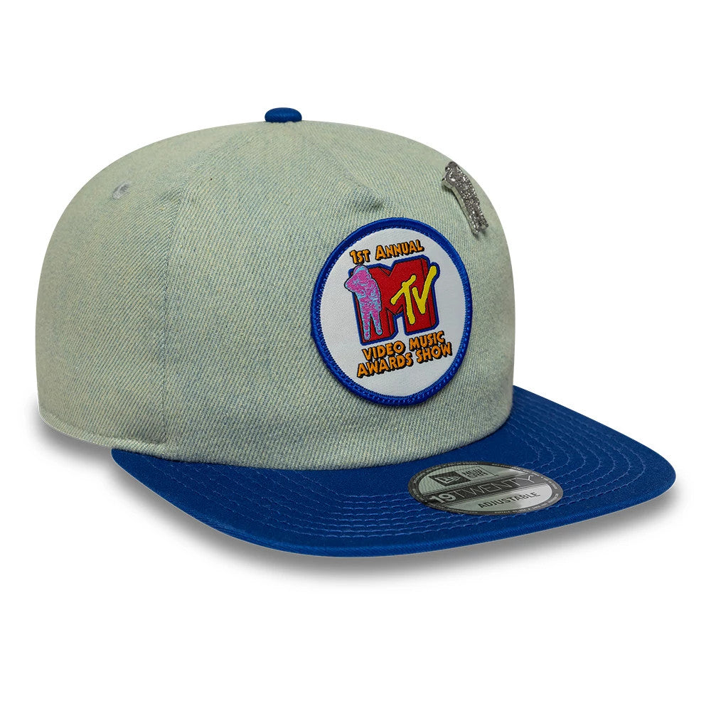 MTV Awards Show Blue New Era 19TWENTY Adjustable Cap, three-quarter view showing a embroidered MTV logo patch on the front panel, a blue visor with a 19TWENTY size sticker, and a small silver embroidered detail near the top.