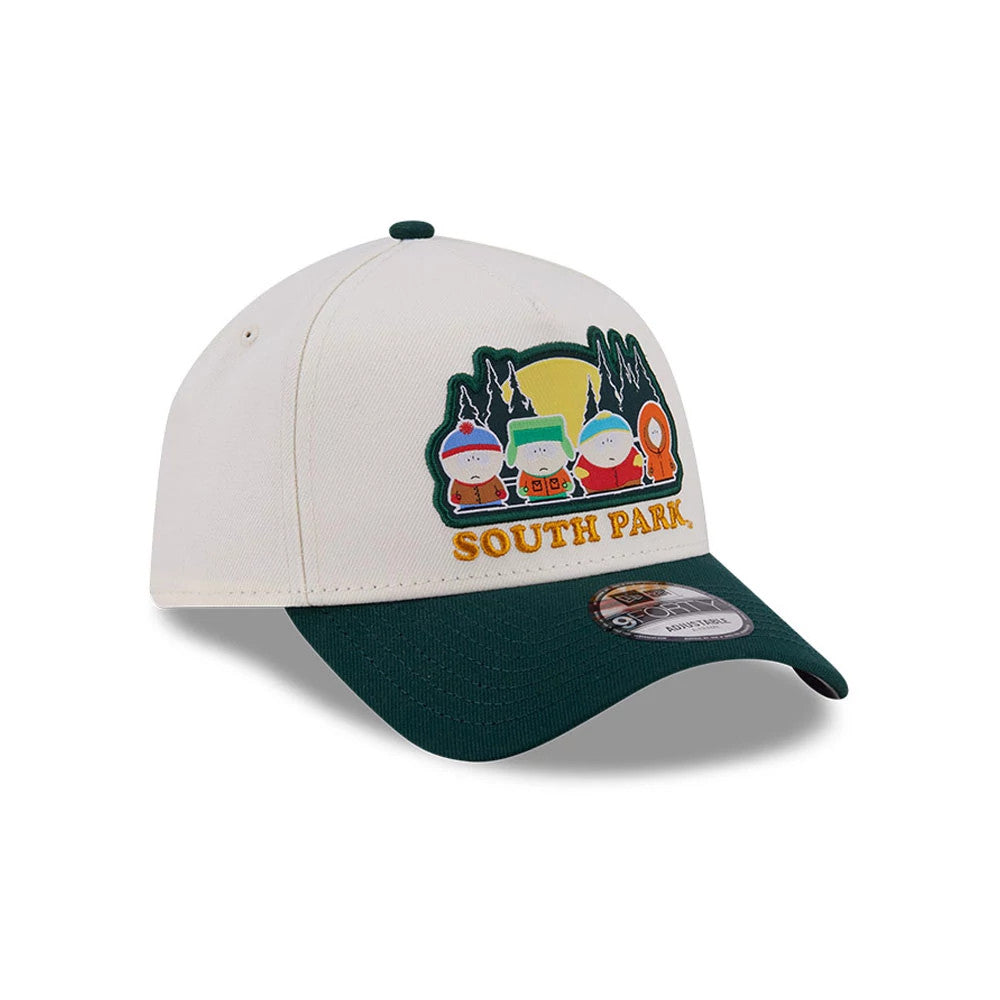 South Park White New Era 9FORTY A-Frame Adjustable Cap, three-quarter view showing a colourful embroidered graphic of South Park characters on the front panel, green curved visor with a 9FORTY size sticker, and a matching top button.