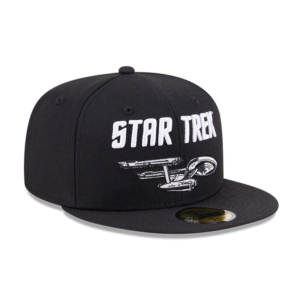 Star Trek Enterprise Black New Era 59FIFTY Fitted Cap, three-quarter view showing the white embroidered Star Trek lettering and Enterprise graphic on the front panel, with a flat black visor and a gold 59FIFTY size sticker.