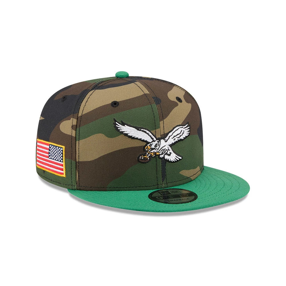 Philadelphia Eagles NFL Camo & Green New Era 9FIFTY Snapback Adjustable Cap, front view showing the raised white eagle logo on the camo front panels, complemented by a green flat visor and 9FIFTY size sticker, with an American flag patch on the side.