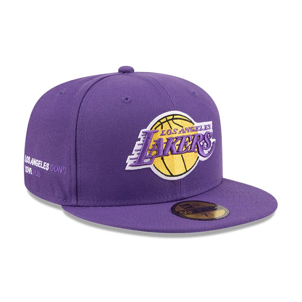 LA Lakers NBA X J-FROST Purple New Era 59FIFTY Fitted Cap, three-quarter view showing a large yellow and purple embroidered Lakers logo on the front panels, with a matching purple flat visor and a gold 59FIFTY size sticker on top.