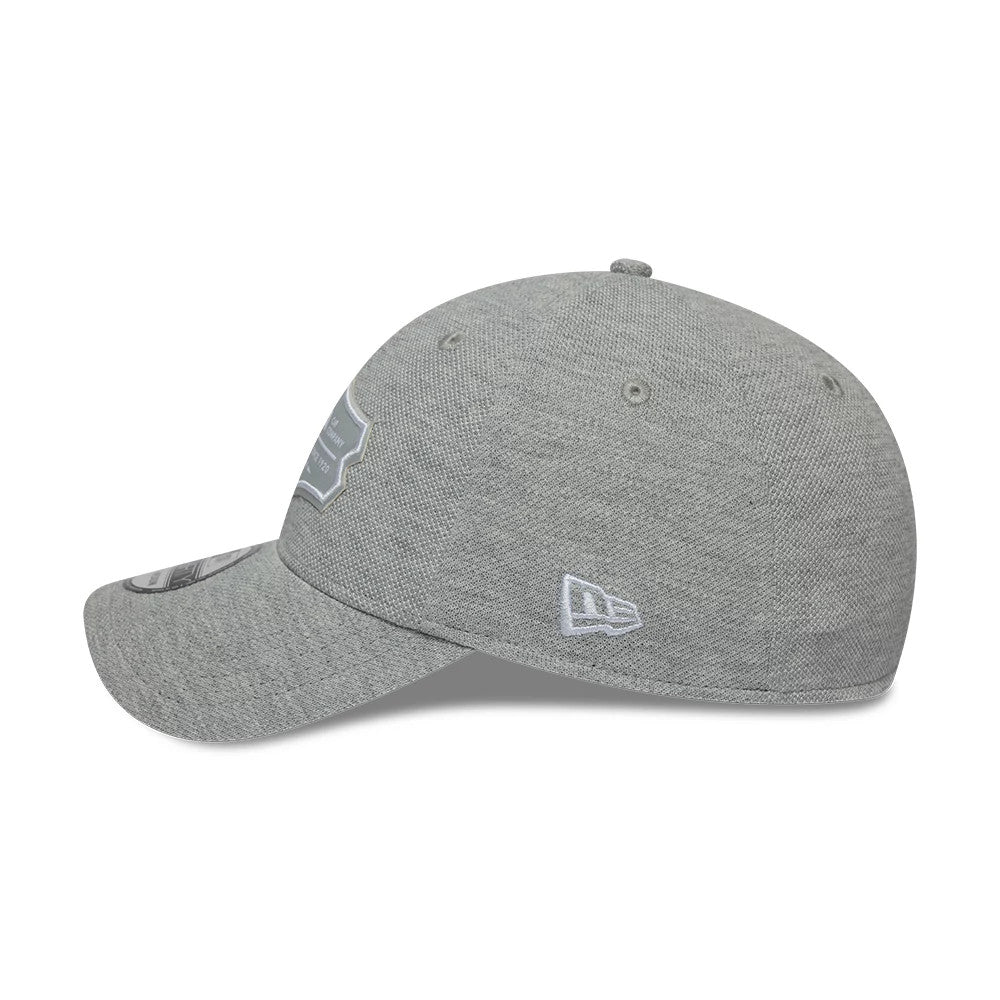 New Era Jersey Grey 39THIRTY Stretch Fit Cap, side view showing the white embroidered New Era flag logo on the left side, a structured grey crown with eyelets, and a curved visor with a grey 39THIRTY size sticker.