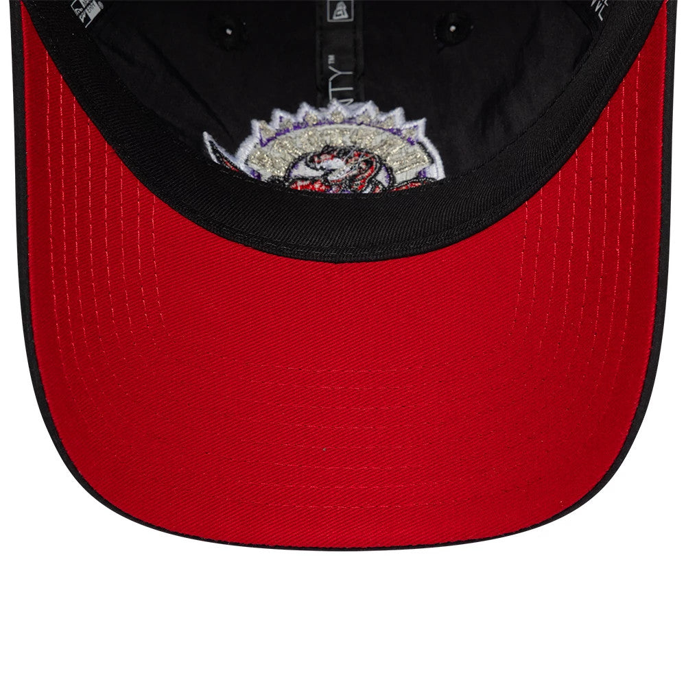 Toronto Raptors NBA Hardwood Classic Nylon Black New Era 9TWENTY Adjustable Cap, inside view showing a red undervisor contrasted with the black sweatband, detailed with interior black taping and the underside of the embroidered front logo.