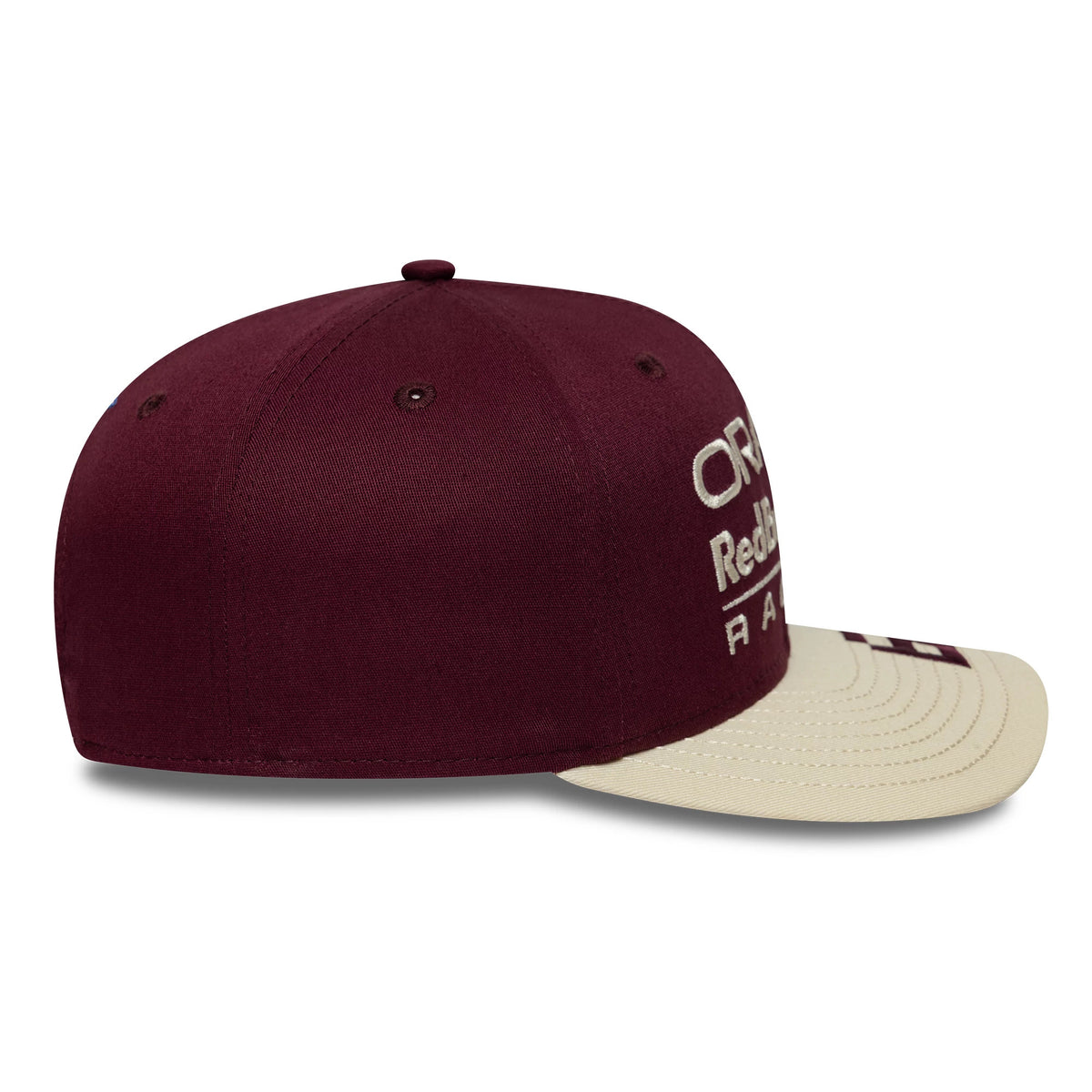 Red Bull Racing Austin Race Special Isack Hadjar Burgundy New Era 9SEVENTY Stretch Snap Cap, side view showing the white embroidered text logo on the front panel, a structured burgundy crown with matching eyelets, and a cream curved visor.