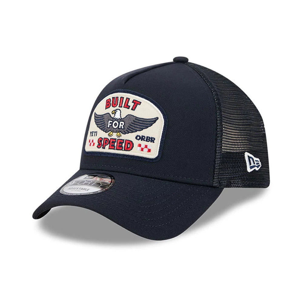 Red Bull Racing Yeti X Red Bull Racing Black New Era 9FORTY A-Frame Trucker Adjustable Cap, three-quarter view showing the Built For Speed embroidered patch with eagle detail on the front panel, black mesh side and rear panels.