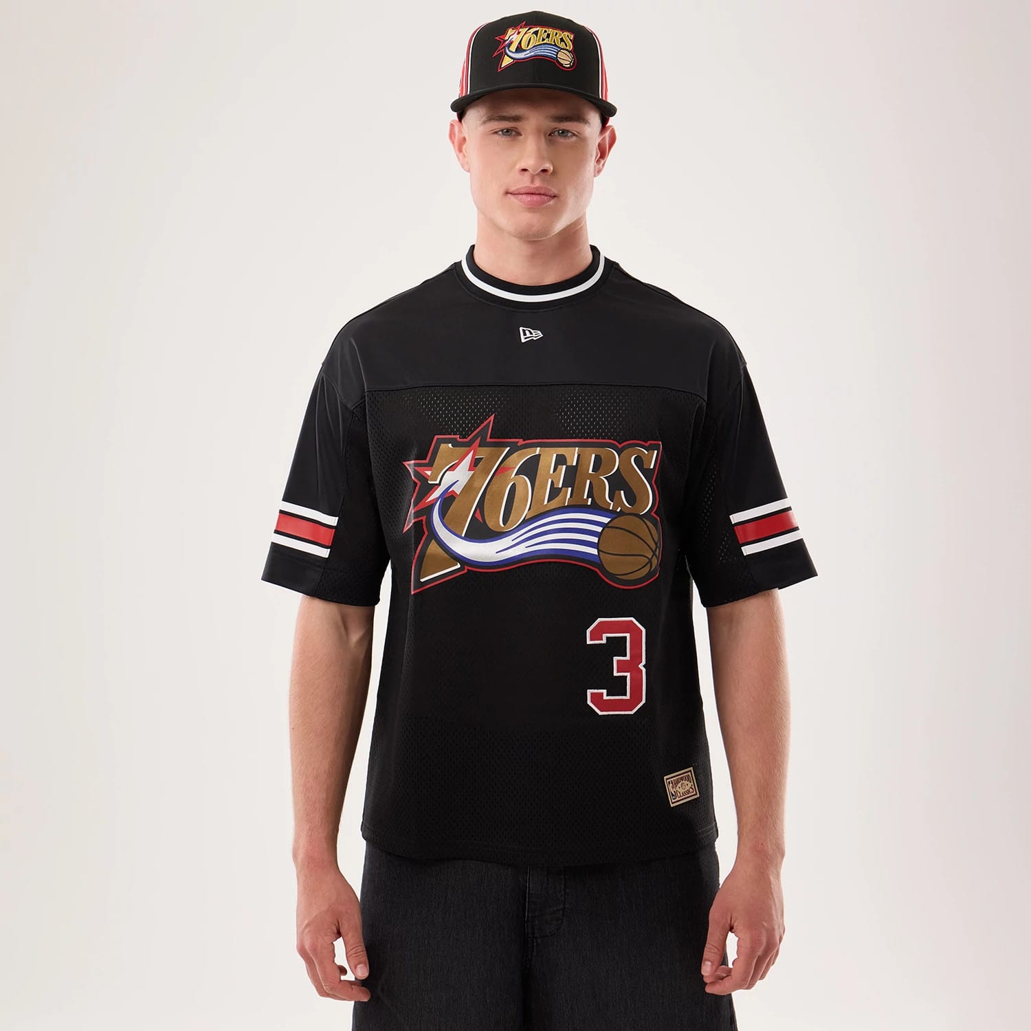 The model is wearing this NBA Hardwood Classic Mesh Oversized Philadelphia 76ers T-Shirt in black. 1