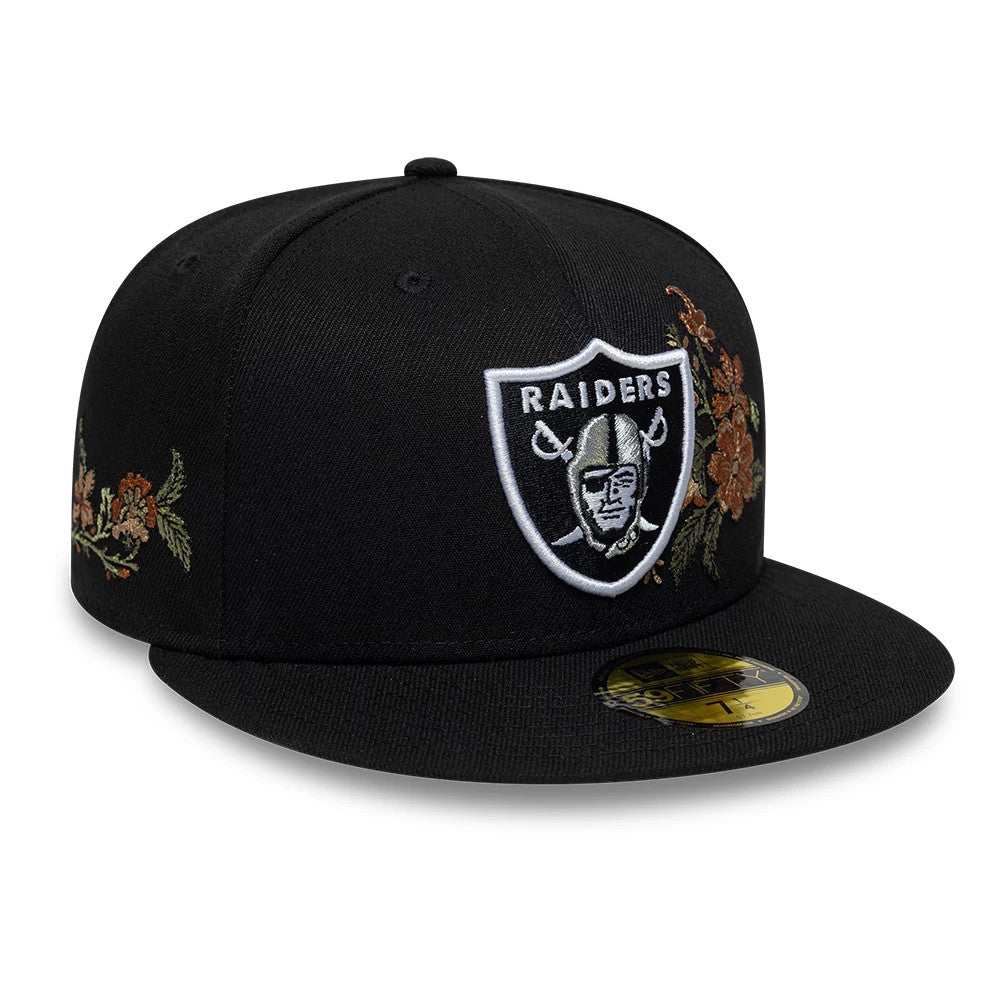 Las Vegas Raiders NFL Floral Black New Era 59FIFTY Fitted Cap, front view showing the white and black embroidered Raiders shield logo on the front panel, with floral embroidery on both sides, and a gold 59FIFTY size sticker on the flat black visor.