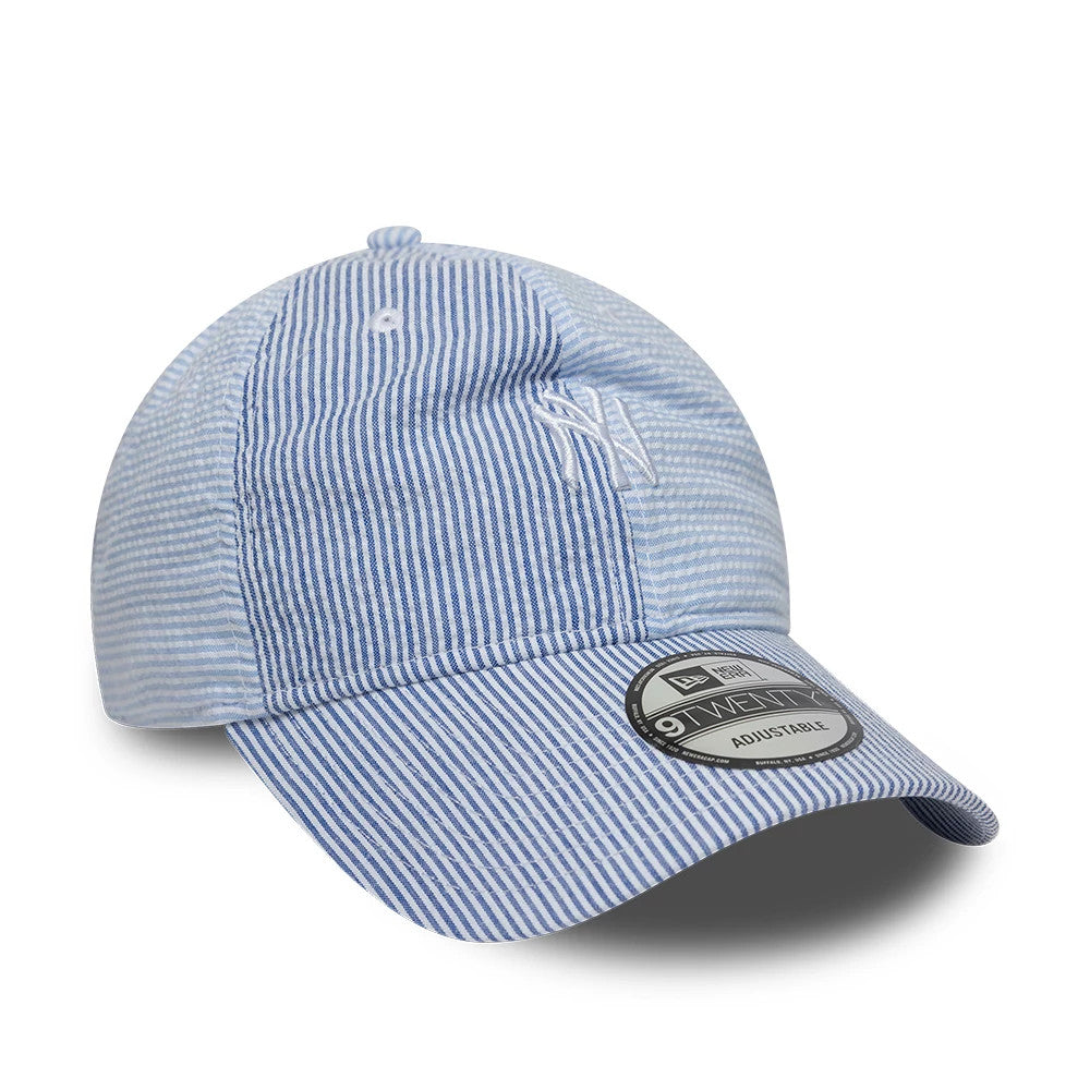 New York Yankees MLB Stripe Pastel Blue New Era 9TWENTY Adjustable Cap, three-quarter view showing white embroidered NY logo on the front panel, curved visor with a 9TWENTY size sticker, and pastel blue and white stripe pattern throughout.