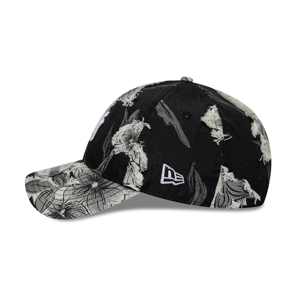 New York Yankees MLB Frayed Black New Era 9TWENTY Adjustable Cap, side view showing the white embroidered New Era flag logo on the left side of the crown, with a detailed black and white floral print across the panels and visor.