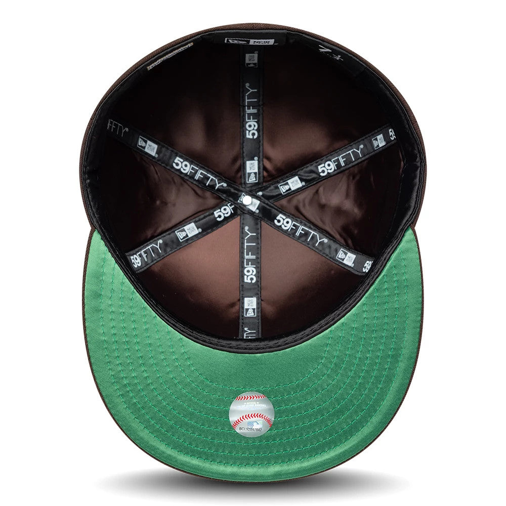 San Diego Padres MLB Cooperstown Dark Brown New Era 59FIFTY Fitted Cap, inside view showing black sweatband featuring repeated white 59FIFTY logos, contrasting green undervisor with a baseball sticker, and dark brown interior panels.