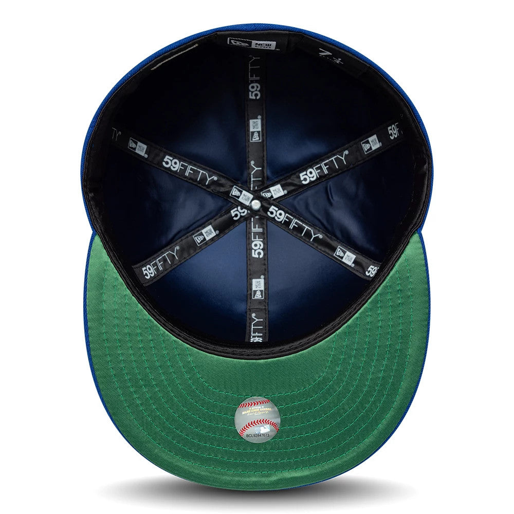 Toronto Blue Jays MLB Cooperstown Blue New Era 59FIFTY Fitted Cap, inside view showing black 59FIFTY-branded taping and a green undervisor, with a baseball-shaped sticker at the centre and a black sweatband around the blue interior.