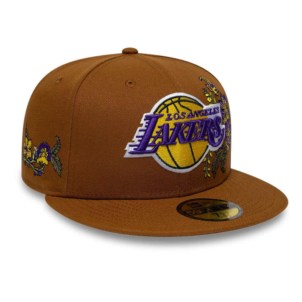 LA Lakers NBA Floral Brown New Era 59FIFTY Fitted Cap, front view showing a large embroidered Lakers logo in purple and gold on the front panels, floral embroidery on the right side, and a gold 59FIFTY size sticker on the flat brown visor.