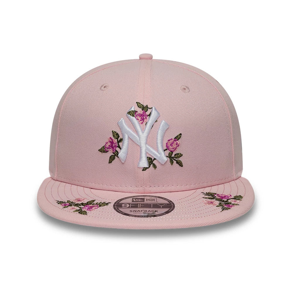 New York Yankees MLB Floral Pastel Pink New Era 9FIFTY Snapback Adjustable Cap, front view showing a white embroidered NY logo with pink floral accents on the structured crown, flat pink visor with matching floral embroidery, and 9FIFTY size sticker.