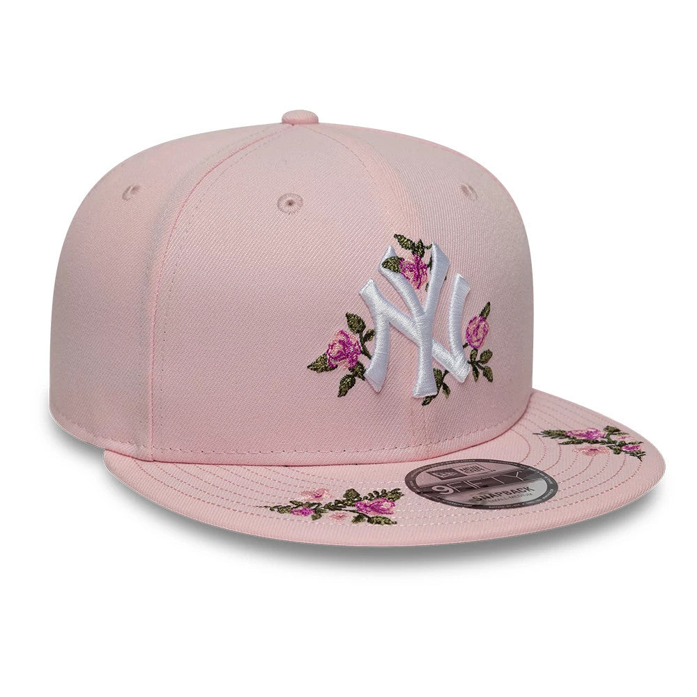 New York Yankees MLB Floral Pastel Pink New Era 9FIFTY Snapback Adjustable Cap, three-quarter view showing the white raised NY logo with pink floral embroidery on the front panels and visor, complete with a 9FIFTY size sticker on the flat pink visor.