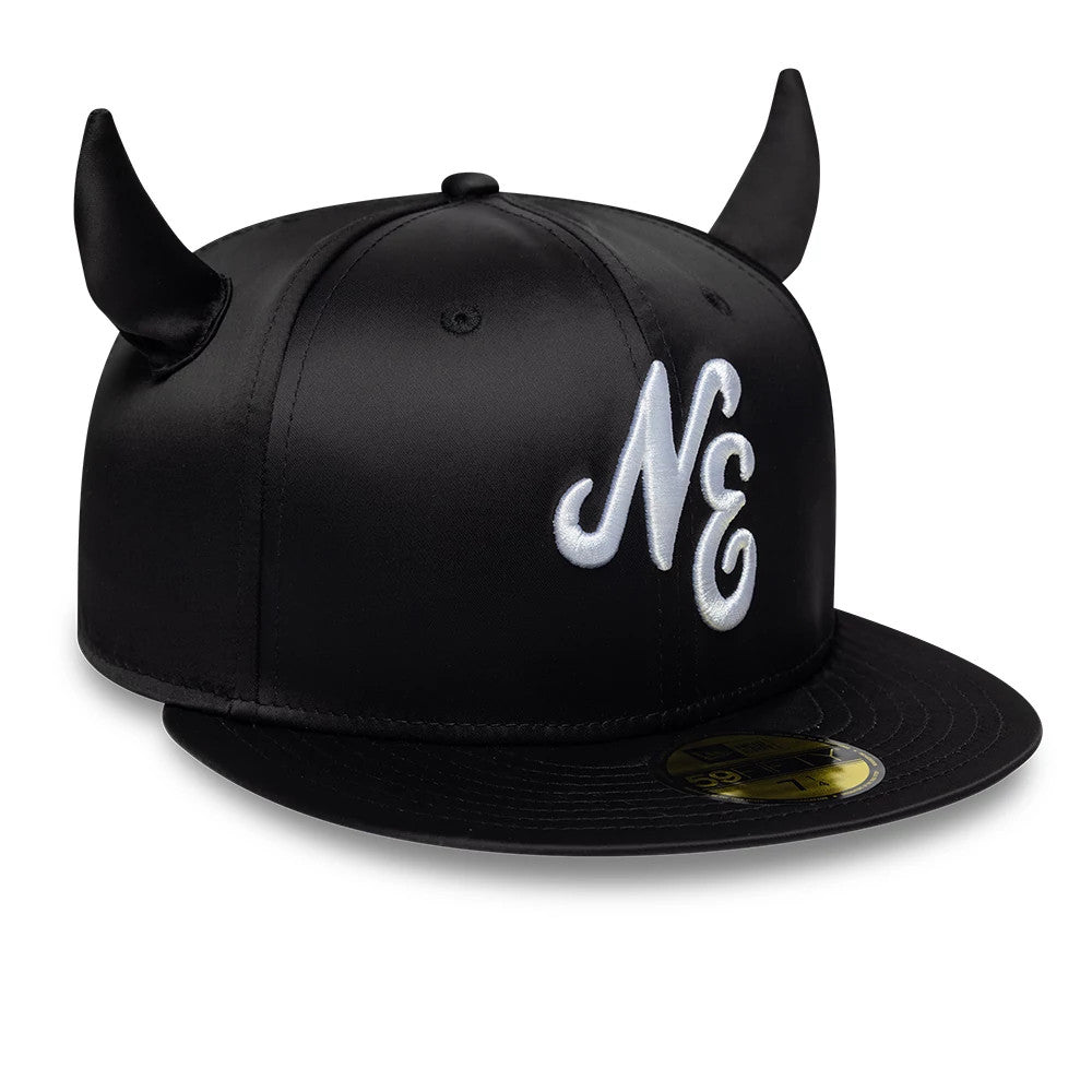 New Era Satin Horn Black 59FIFTY Fitted Cap, three-quarter view showing the raised white embroidered NE logo on the front panel, black satin fabric, and a flat black visor with a gold 59FIFTY size sticker, topped with black horn accents.