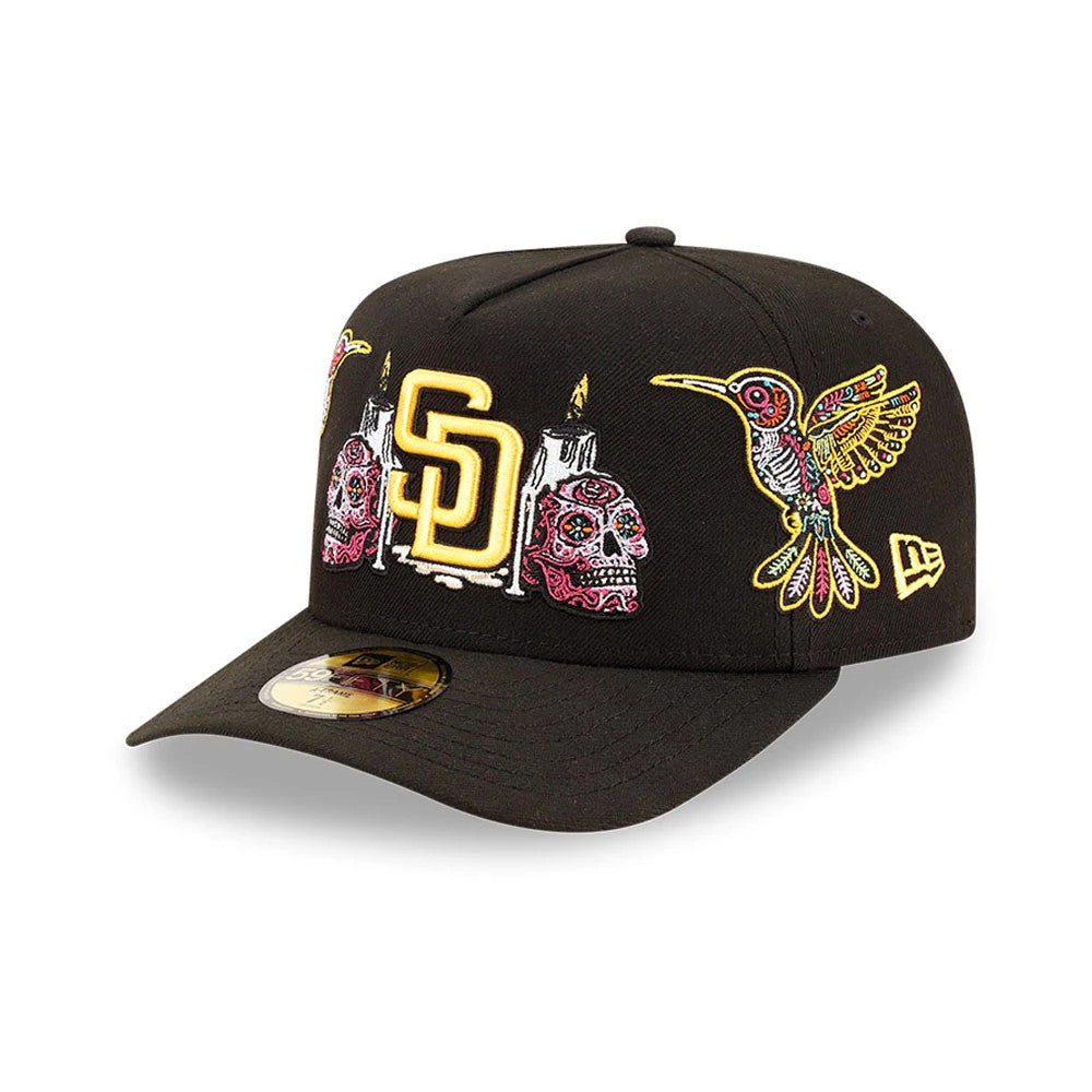 San Diego Padres MLB Day Of The Dead Black New Era 59FIFTY A-Frame Fitted Cap, three-quarter view showing intricate yellow SD logo, colourful sugar skulls and candles embroidery on front, with a prominent hummingbird.