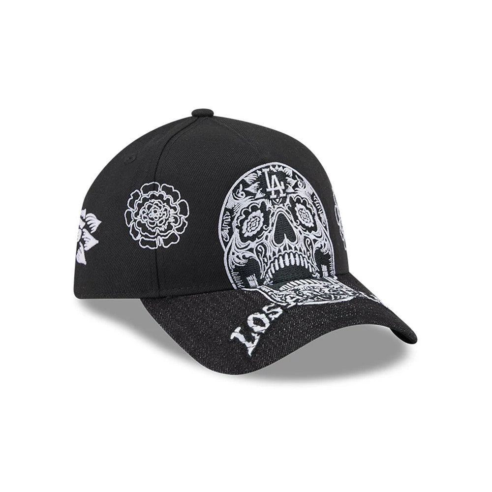 LA Dodgers MLB Day Of The Dead Black New Era 9FORTY A-Frame Adjustable Cap, three-quarter view showing a detailed white embroidered sugar skull design on the front panel, floral accents on the side, and embroidered 'Los Angeles' text on the visor.