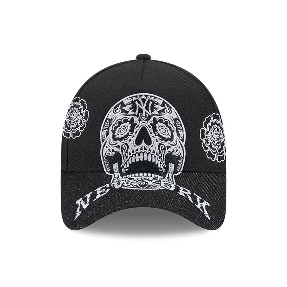 New York Yankees MLB Day Of The Dead Black New Era 9FORTY A-Frame Adjustable Cap, front view showing a detailed white embroidered sugar skull design on the crown, intricate floral patterns on the sides, and New York text on the black curved visor.