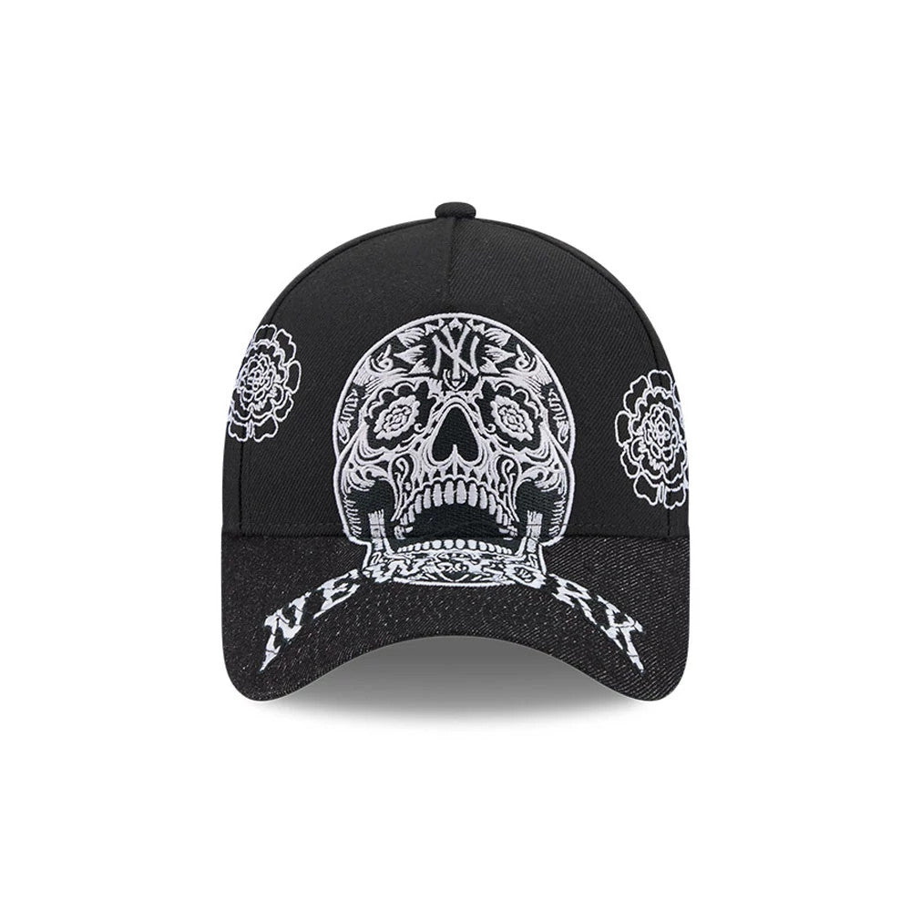 New York Yankees MLB Day Of The Dead Black New Era 9FORTY A-Frame Adjustable Cap, front view showing a detailed white embroidered sugar skull design on the crown, intricate floral patterns on the sides, and New York text on the black curved visor.