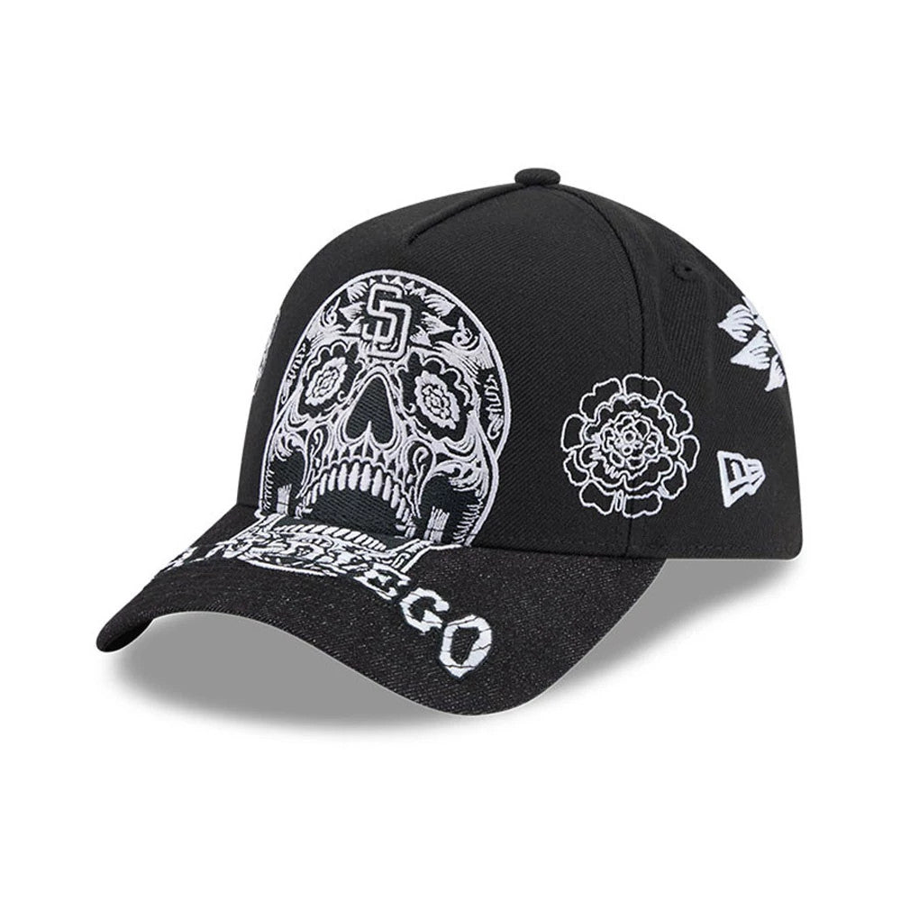 San Diego Padres MLB Day Of The Dead Black New Era 9FORTY A-Frame Adjustable Cap, three-quarter view showing a white embroidered sugar skull design on the front panels, San Diego lettering on the curved black visor, and floral motifs on the sides.