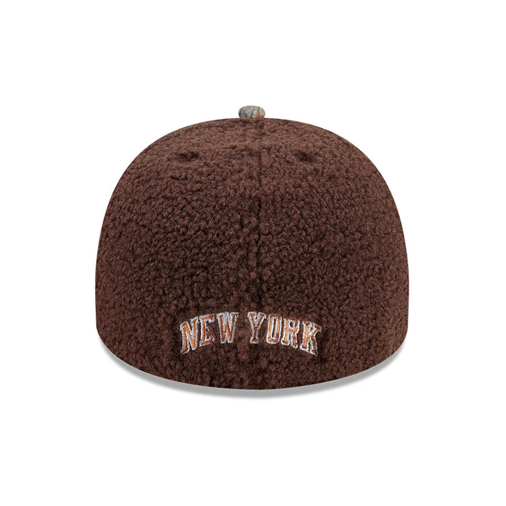 New York Knicks NBA Hardwood Classic Brown New Era 59FIFTY A-Frame Fitted Cap, rear view showing New York embroidered in white and orange on the plush brown textured fabric, with a patterned top button and no New Era flag logo.