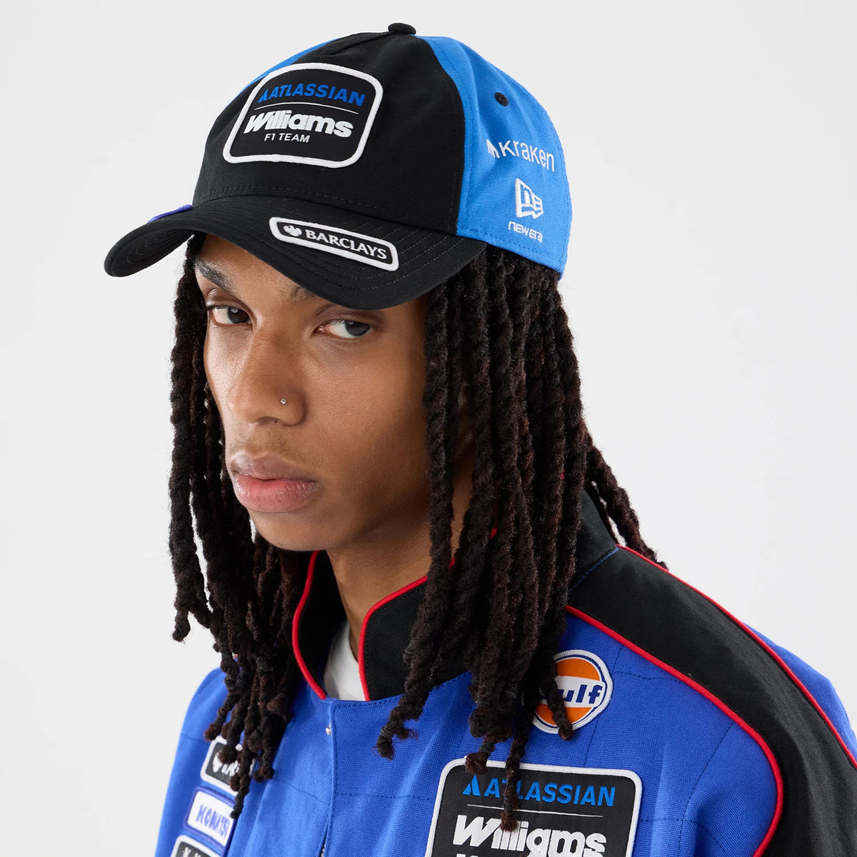 Williams Vegas Race Special Black New Era 9TWENTY A-Frame Adjustable Cap, on-model view showing the front embroidered Williams F1 Team logo patch, contrasting blue side panels with white KRAKEN text, and New Era flag logo on the left side.
