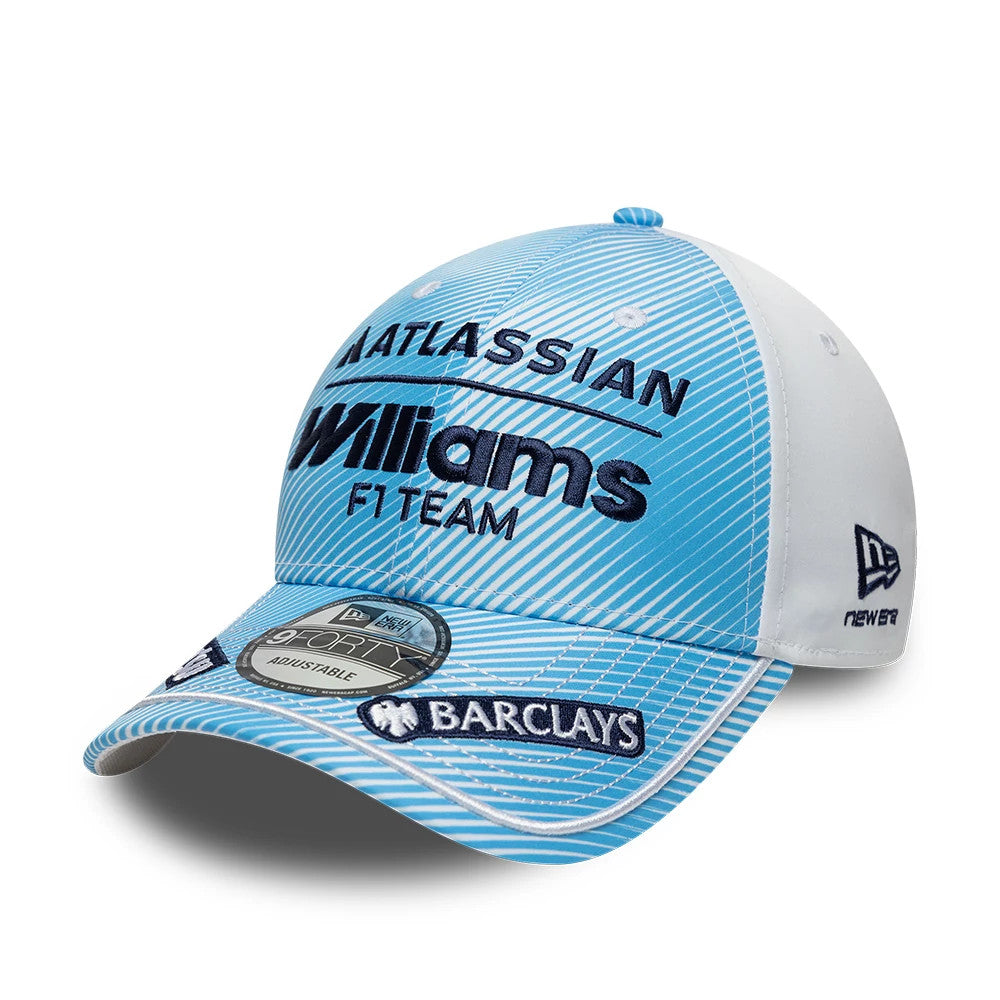 Williams Carlos Sainz Spain Race Special Blue New Era 9FORTY Adjustable Cap, three-quarter view showing navy embroidered Williams F1 Team lettering on the patterned blue front panels, a grey 9FORTY size sticker on the visor, and white side panels.