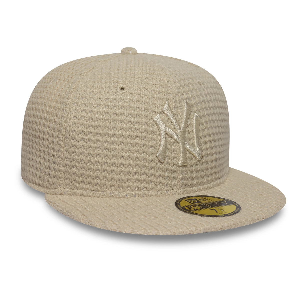 New York Yankees MLB Knitted Light Beige New Era 59FIFTY Fitted Cap, three-quarter view showing the raised beige Yankees logo embroidered on the structured knitted crown, with a matching light beige visor and gold 59FIFTY size sticker.