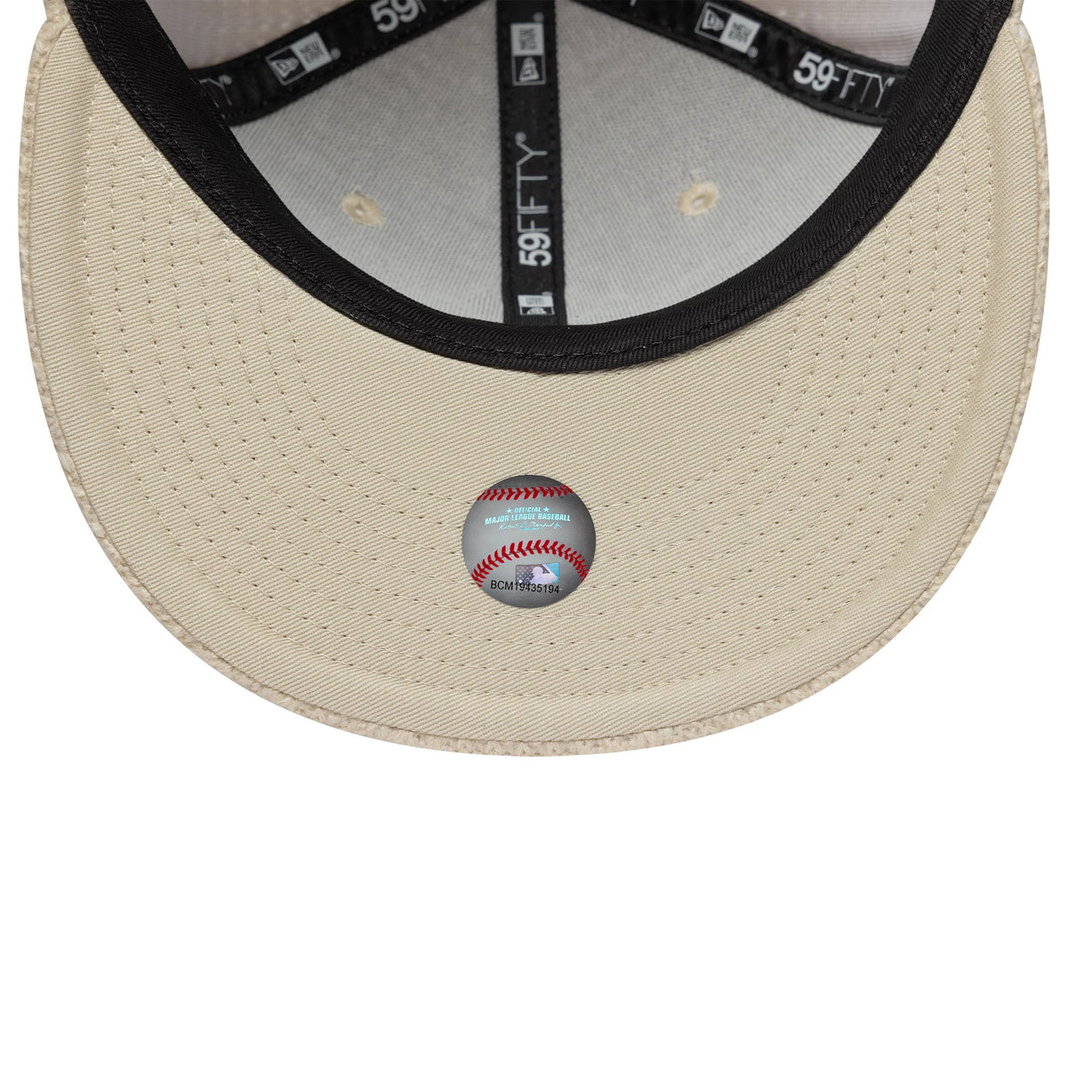 New York Yankees MLB Knitted Light Beige New Era 59FIFTY Fitted Cap, inside view showing the black New Era branded taping, the matching beige undervisor, and a white baseball design sticker placed centrally on the visor.