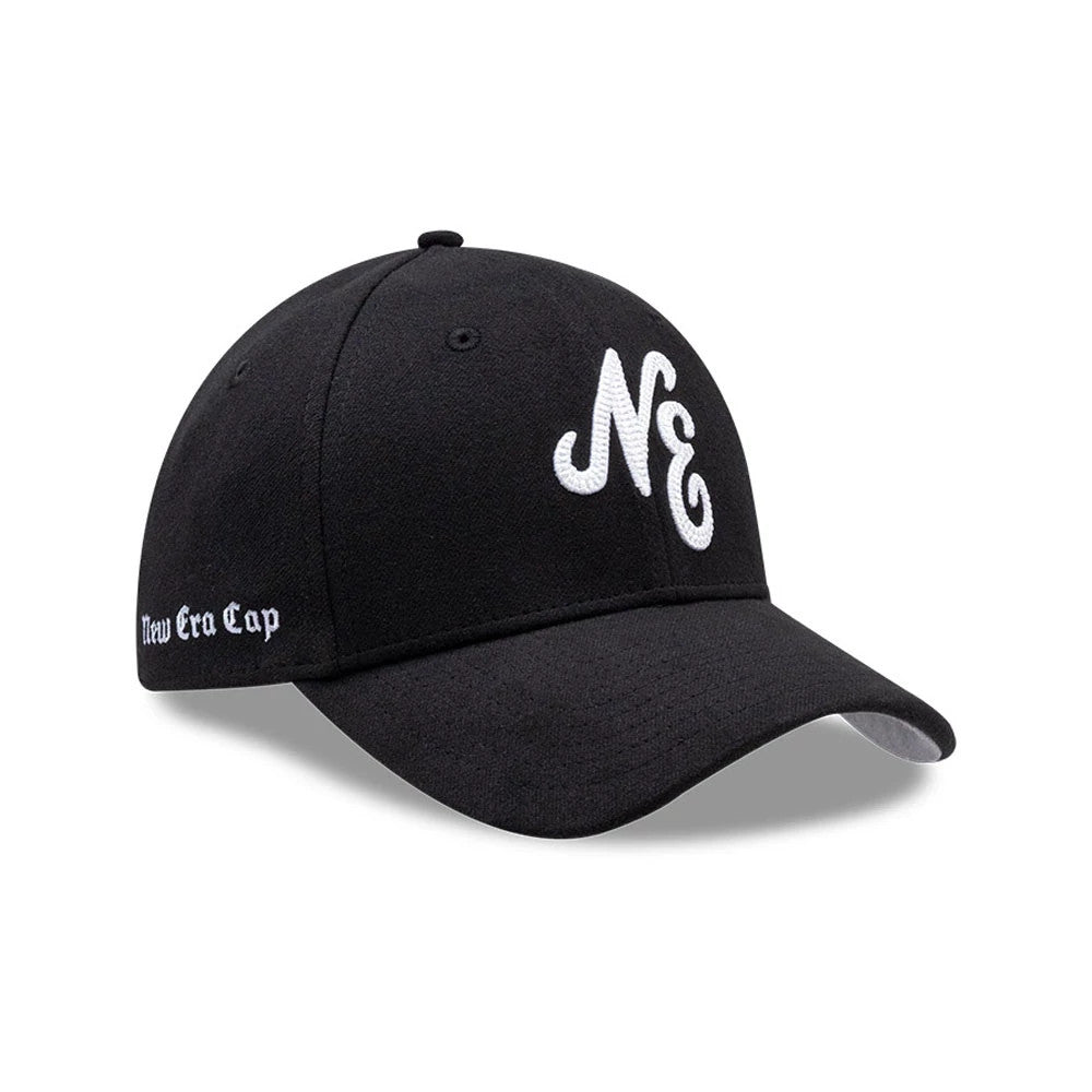New Era Melton Black New Era 39THIRTY Stretch Fit Cap, three-quarter view showing the raised white embroidered NE logo on the front panel, curved black visor, and New Era Cap lettering embroidered in white on the left side.
