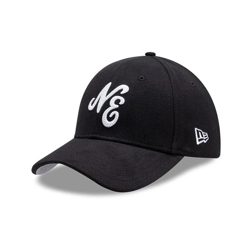 New Era Melton Black 39THIRTY Stretch Fit Cap, three-quarter view showing a white embroidered NE logo on the front panel, a curved black visor, and the New Era flag logo in white stitching on the left side.