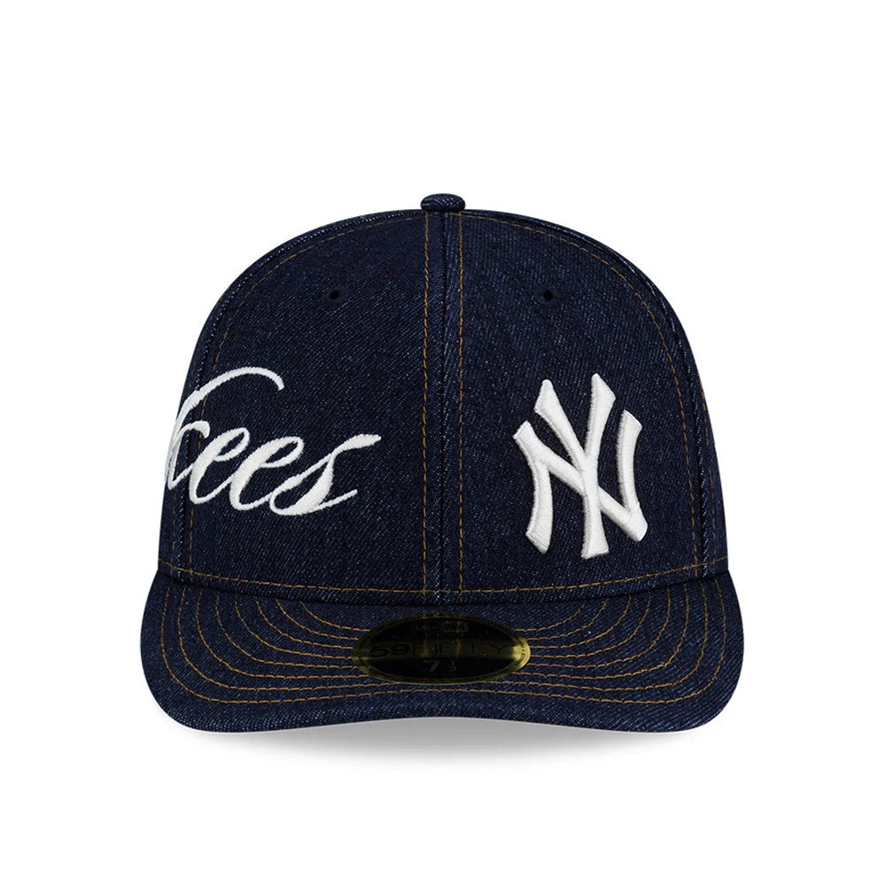 New York Yankees MLB Denim Navy Low Profile New Era 59FIFTY Fitted Cap, front view showing white Yankees script embroidery across the front panel with the NY logo, navy denim fabric, and a gold 59FIFTY size sticker on the flat visor.