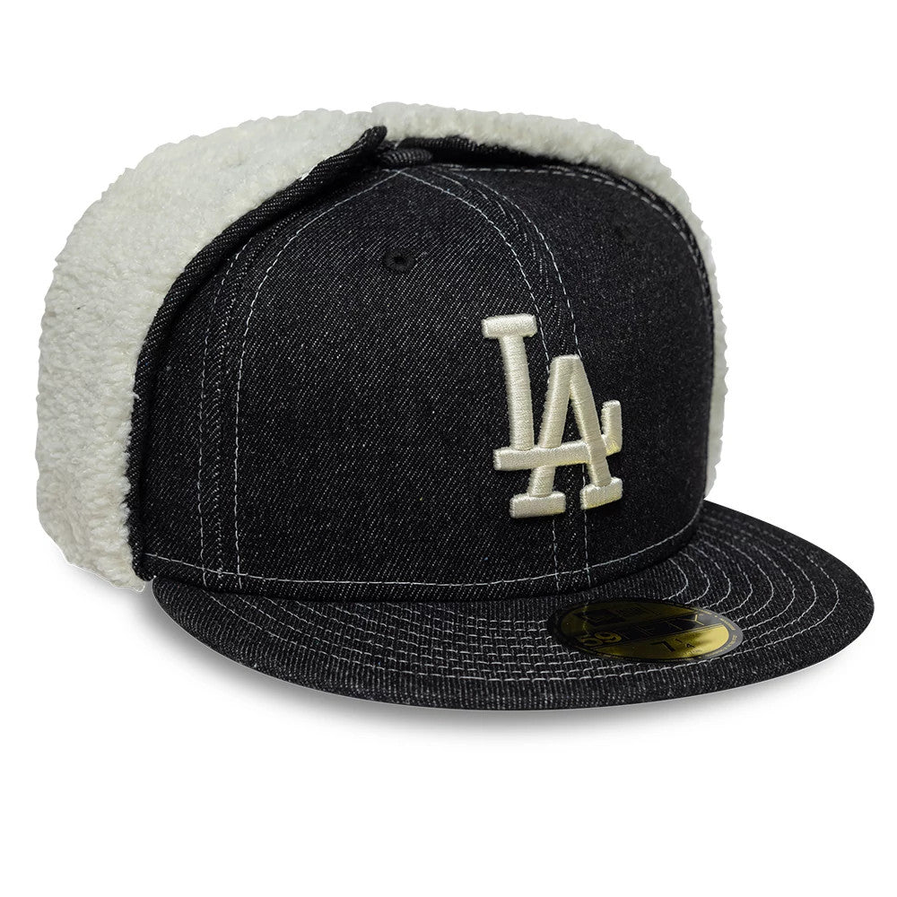 LA Dodgers MLB Denim Black Dogear New Era 59FIFTY Fitted Cap, three-quarter view showing cream raised embroidery LA logo on the black denim front panel, black flat visor with gold 59FIFTY size sticker, and white fleece dogear flaps.