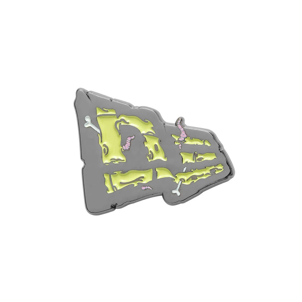 New Era Halloween Worm Grey Pin Badge, front view showing a grey pin shaped like the New Era cap logo, featuring an eerie design with yellow accents resembling distressed fabric, pink worms crawling through and small bone details.