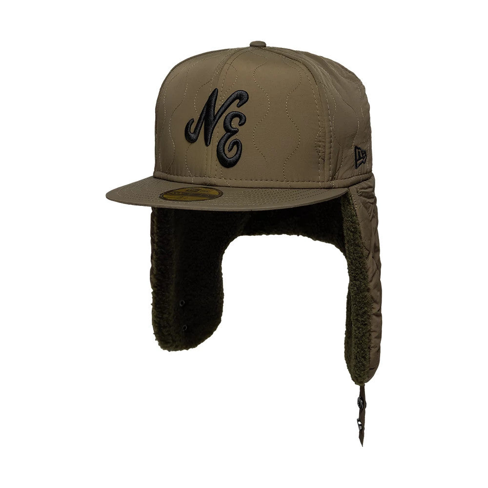 New Era Quilted Dark Green Dogear 59FIFTY Fitted Cap, three-quarter view showing a black raised embroidered NE logo on the front panel, a quilted design on the structured dark green crown, and black 59FIFTY size sticker on the flat visor.