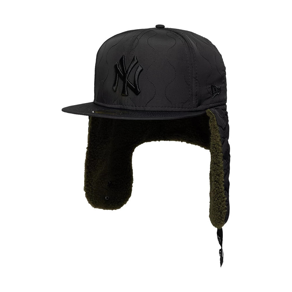 New York Yankees MLB Quilted Black Dogear New Era 59FIFTY Fitted Cap, three-quarter view showing a black raised embroidered NY logo on the front panel, a matching flat visor, and quilted ear flaps with olive-green inner lining.