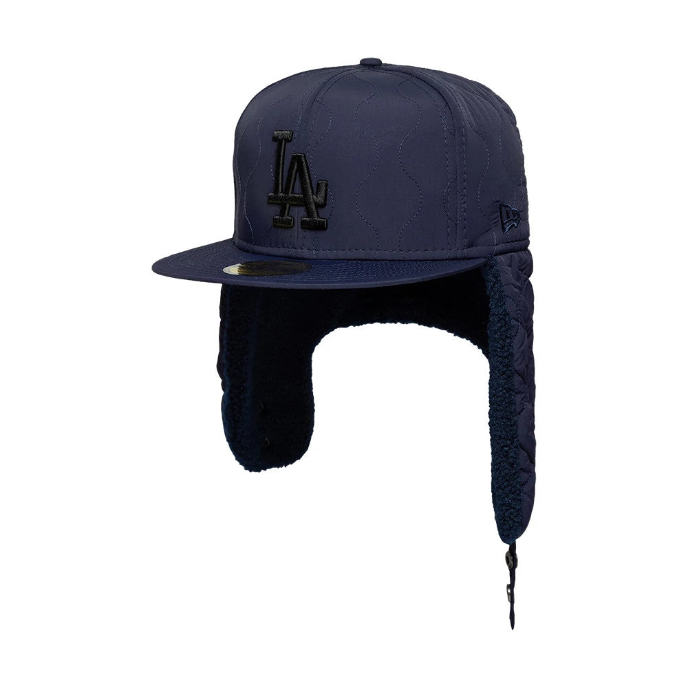LA Dodgers MLB Quilted Navy Dogear New Era 59FIFTY Fitted Cap, three-quarter view showing the raised black LA logo on the front panel, a matching navy visor with gold 59FIFTY size sticker, and quilted ear flaps with button closure.
