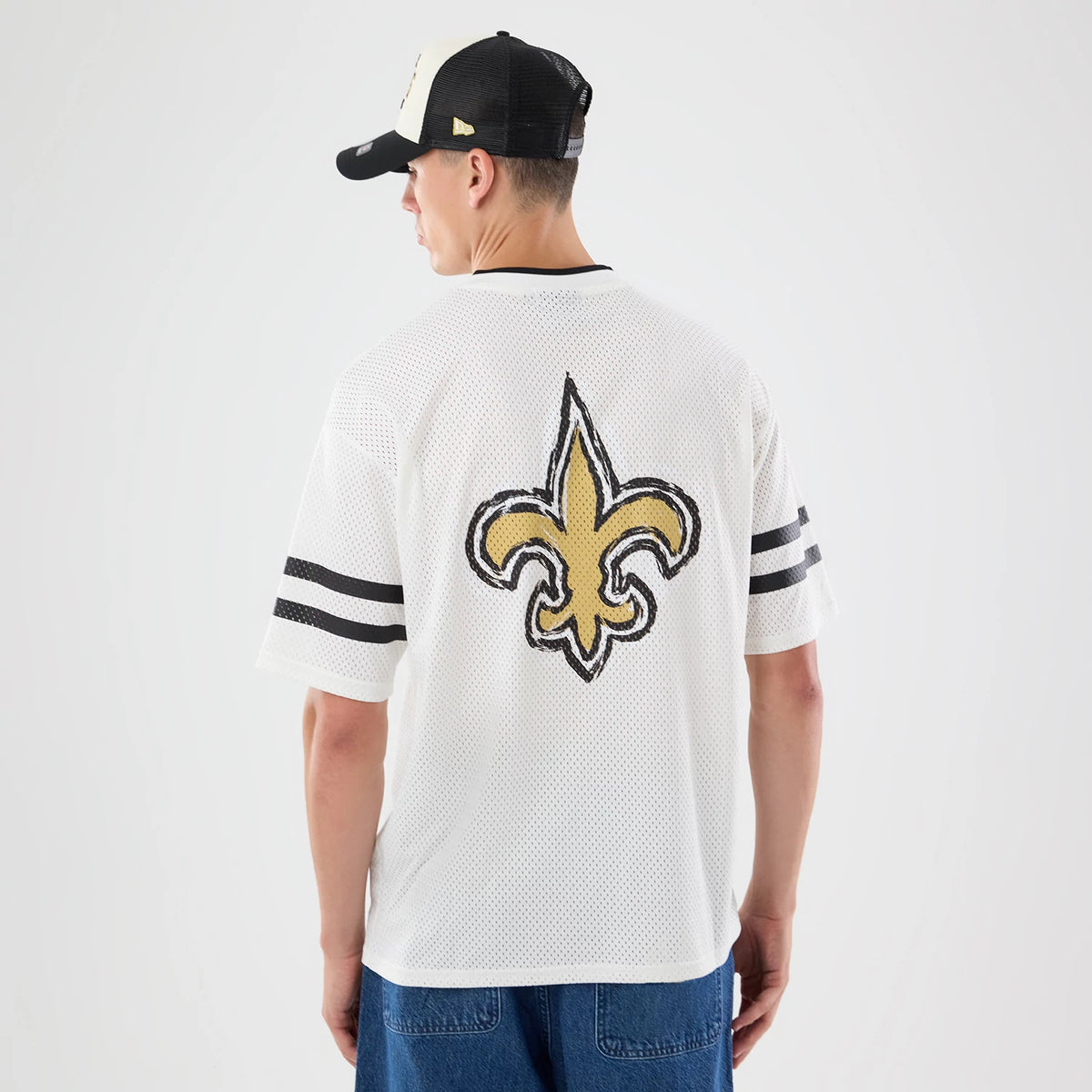 The model is wearing this NFL International Games 2026 Graphic New Orleans Saints Mesh Jersey in white. 2